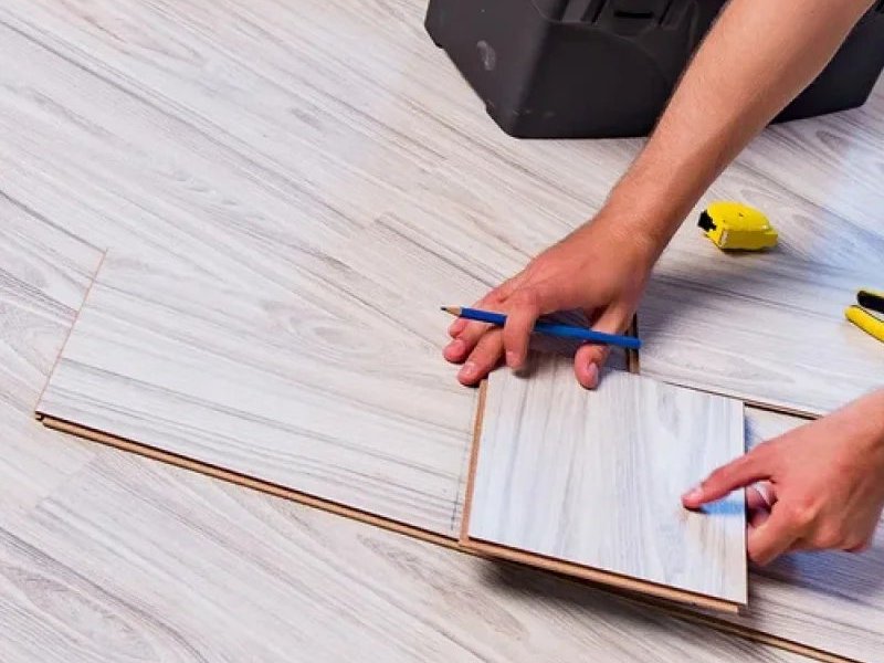 Flooring contractor installing luxury vinyl plank flooring