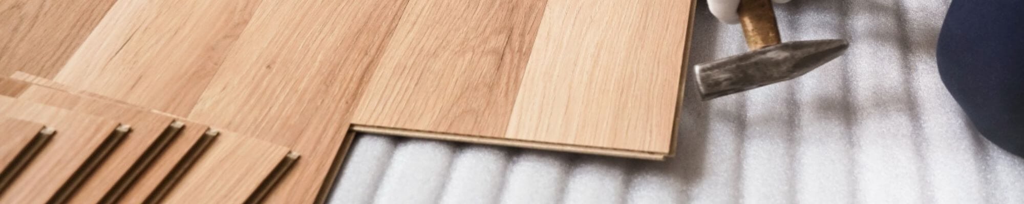 Flooring professional in Surprise, AZ installing a wood floor